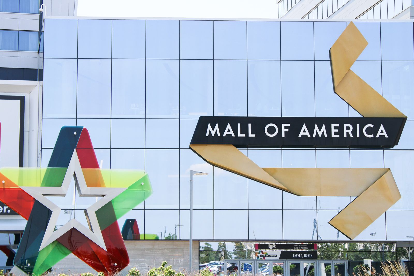 The Mall of America sign on the glass facade of the mall in Bloomington, Minnesota, beside a large multicolored star